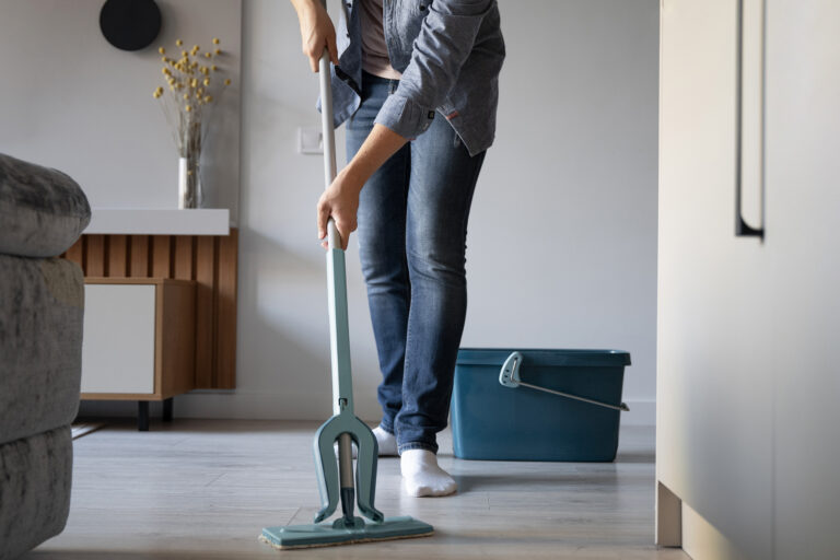 a person cleaning the floor of an airbnb