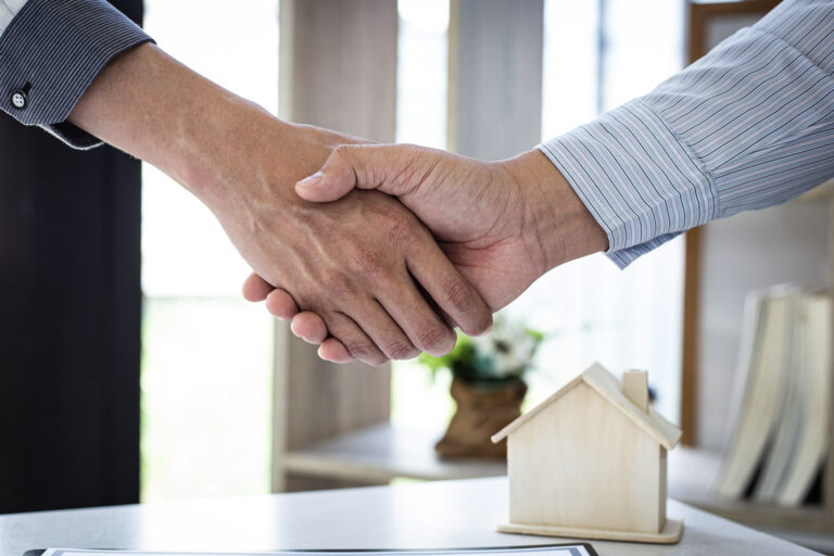 airbnb hosts shaking hands in an airbnb