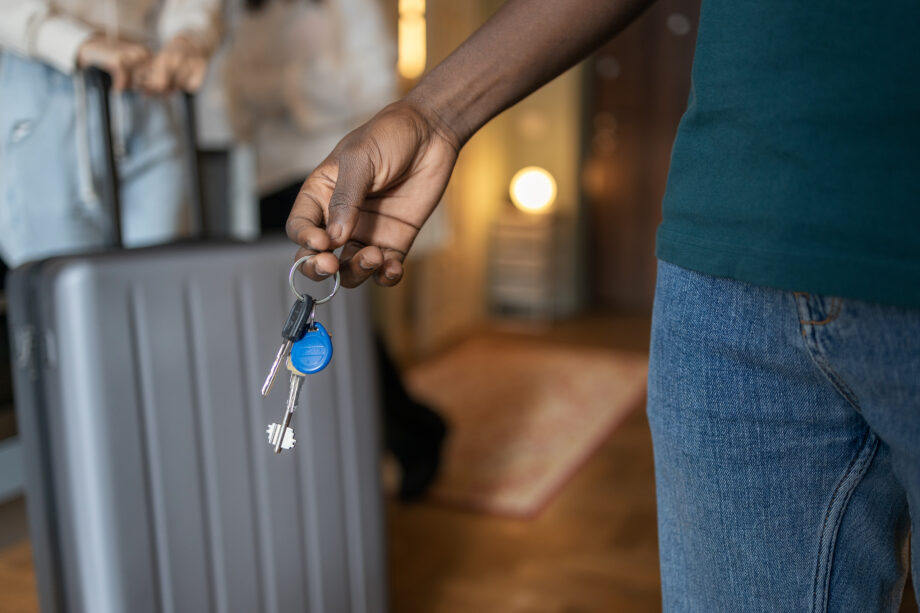 a man holding keys to an airbnb
